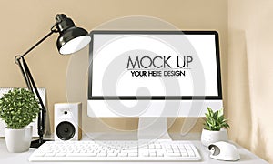 Mock up poster computer in office zen style and decoration on top table office.3D rendering