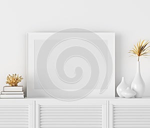 Mock up poster frame on chest of drawers near white wall, Scandinavian style