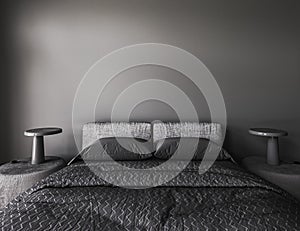 Mock-up poster in modern dark bedroom interior with lamp on table. Bed with gray blanket and pillows. Black empty wall