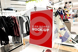 Mock up sign board in fashion clothes shop