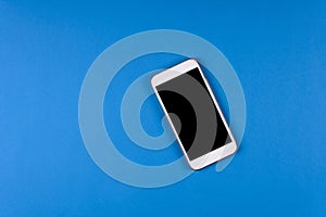 Mock-up smartphone on blue background. Flat lay. Copy space. Top view