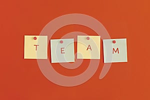 Mock up sticky notes with TEAM on red background. Business concept, strategy, planning