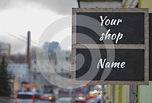 Mock up for street shop or boutique signboard . View of blured street in a cloudy weather