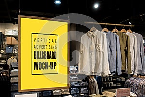 Mock up vertical billboard hanging in clothes shop for men