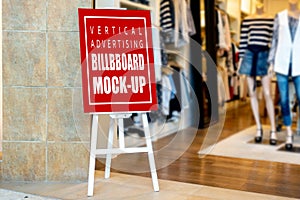 Mock up vertical signboard on stand at clothing store