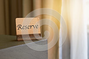 Mock up vintage brown paper sign or symbol label card holder on corner of table