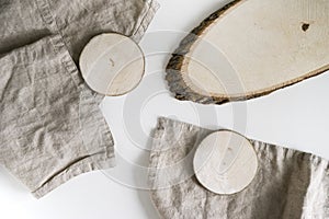 mock up white background crumpled beige linen napkins linen texture. there are two small round brown wooden coasters on