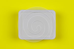 Mock-up white plastic box on yellow background top view, disposable packaging for products