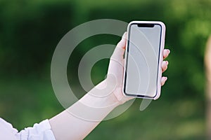 Mock up woman hold smartphone in left hand