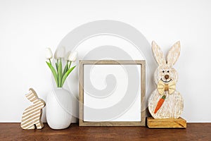 Mock up wood frame with rustic Easter decor on a wood shelf