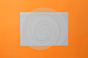 mock-ups paper on orange background, white paper Blank portrait A4.