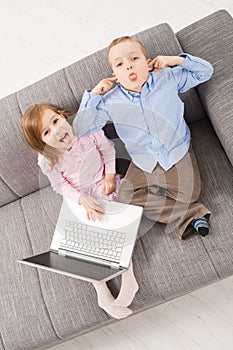 Mocking children with laptop