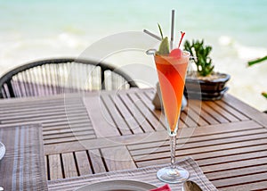 Mocktail mixed fruits with lime and cherry on wooden dining table