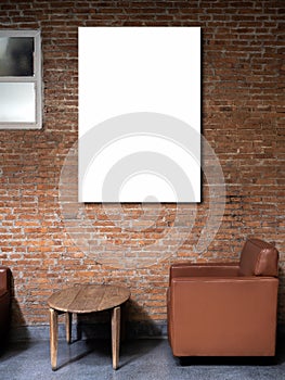 Mockup artist frame or white blank vertical poster on red brick wall background over the empty vintage brown single sofa seat.