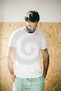 Mockup of a bearded man wearing white tshirt and photo