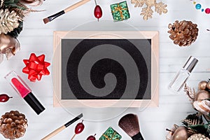 Mockup beauty Christmas New Year concept. Mock up blank empty space chalkboard with makeup cosmetic and Christmas decoration