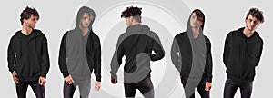 Mockup of black hoodie with pocket, zip fastener on posing guy in jeans, isolated on background