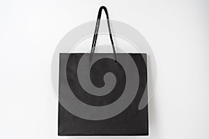 Mockup of black paper shopping bag on white background