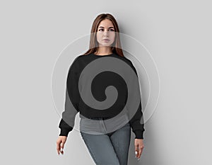 Mockup of black sweatshirt on pretty girl in jeans, casual apparel isolated on white background, front view