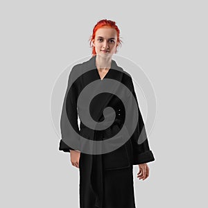 Mockup of a black terry bathrobe with a belt on a red-haired girl, a winter robe for design, branding, front view