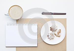 Mockup with blank notepad, cup of coffee and biscuit. New year cookies and cappuccino. Christmas morning still life.