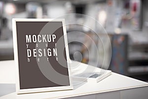 Mockup blank picture frame template for Photo or picture painting art gallery in living room at night on the table