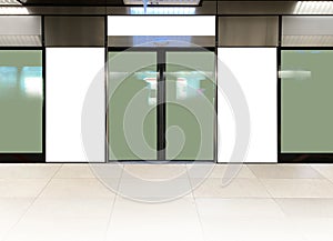 Mockup of blank poster advertising space in generic train station; OOH mock up. Straight front view of MRT platform, without