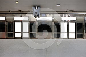 Mockup of blank posters, banners in generic train station; advertising space; OOH mock up. Straight front view of MRT platform,