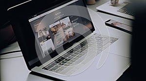 Mockup blank screen laptop on wood table in co-working space.