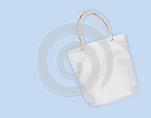 Mockup of blank white fabric bag isolated on blue background