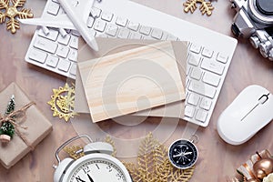 Mockup blank wood board for Christmas New Year holiday travel background concept on home office desk, Flat lay top view mock up
