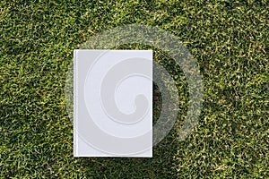 Mockup book on green grass background