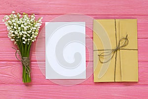 Mockup with bouquet and empty greeting card, gift box, envelope top view, copy space for text, flat lay