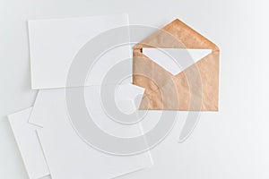 Mockup brown kraft envelope and enpty cards on white background