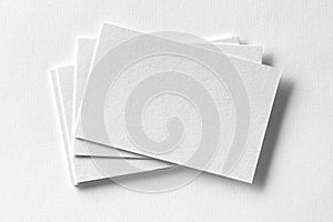 Mockup of business cards fan stack at white textured paper