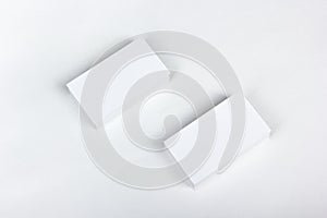 Mockup of business cards fan stack at white textured paper background. Top view.