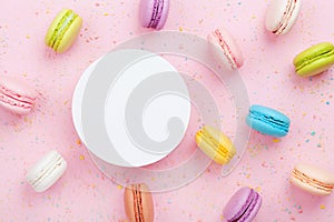 Mockup with cake macaron or macaroon on pink pastel background top view. Flat lay composition.