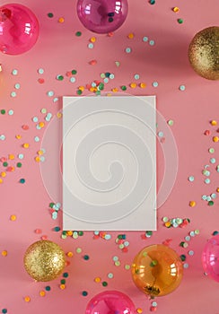 Mockup card on a pink background with their Christmas decorations and confetti. Invitation, card, paper. Place for text