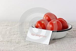 Mockup with a cardboard business card and enameled bowl with tomatoes