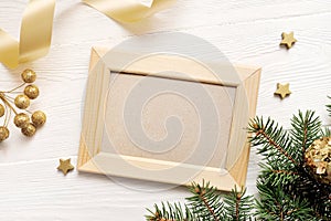 Mockup Christmas greeting card top view and wood frame, flatlay on a white wooden background with a ribbon, with place