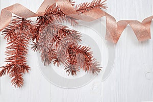 Mockup Christmas tree branch and gold gift ribbon, flatlay on a white wooden background, with place for your text