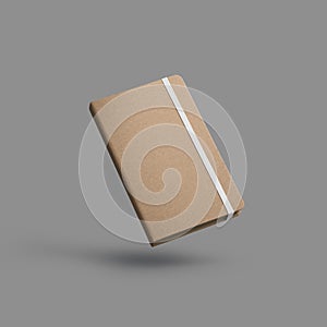 Mockup of closed textured craft notebook with white band, notepad in the air, isolated on gray background with shadows