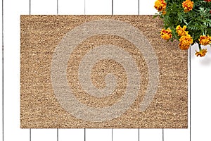 Mockup of Coir Doormat on wooden floor with flowers