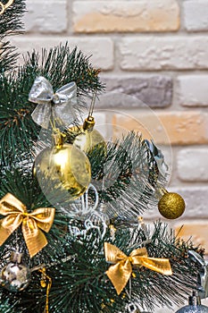 Mockup with decorated Christmas tree. Composition with gold and silver baubles, bows, animals, bells, lit garlands. Copy-space on