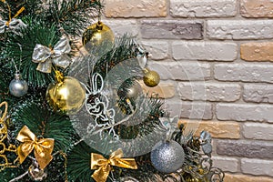 Mockup with decorated Christmas tree. Composition with gold and silver baubles, bows, animals, bells, lit garlands. Copy-space on
