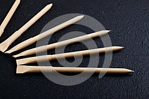 Mockup design. set of beige pens on the dark wooden background. composition