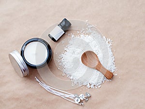 mockup of essential oil bottle, glass candle and wicks for candle making on soy wax flakes