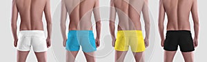 Mockup fashionable white; black, Ukrainian colors trunks, summer panties on guy, isolated on background in studio, back view