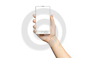 Mockup of female hand holding frameless cell phone with blank screen