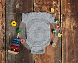 Mockup Flat Lay of heather gray baby bodysuit shirt o